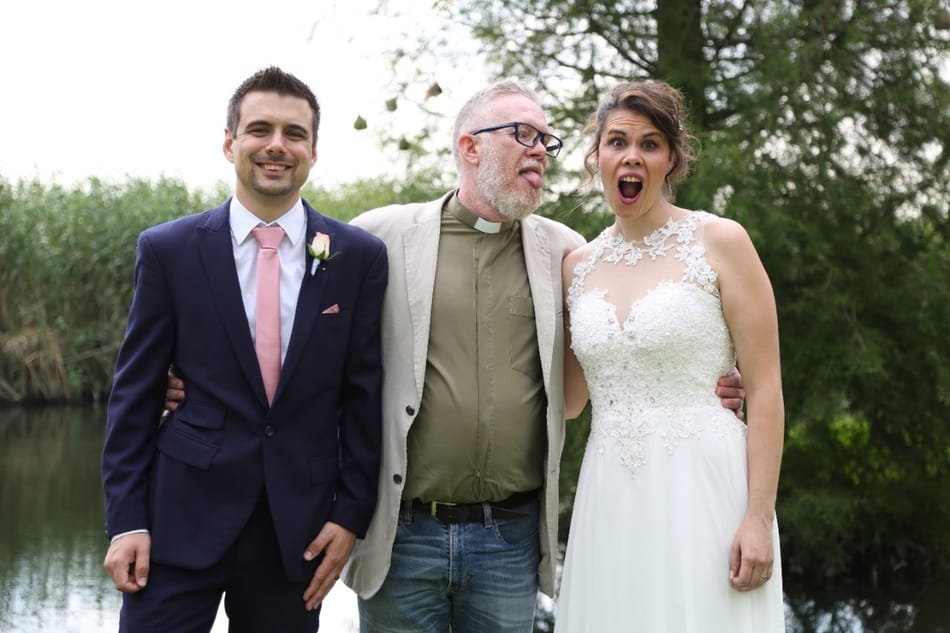 Nick smiling at an outdoor wedding ceremony in a kilt