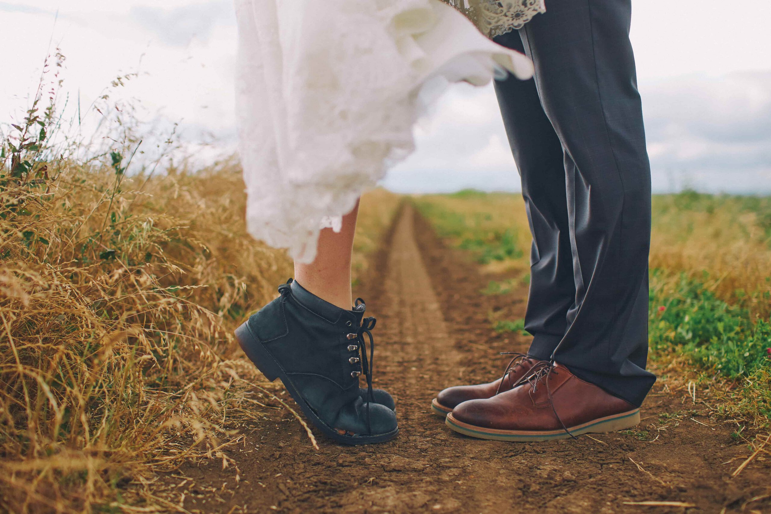 A couple's boots in a field — an intimate outdoor ceremony